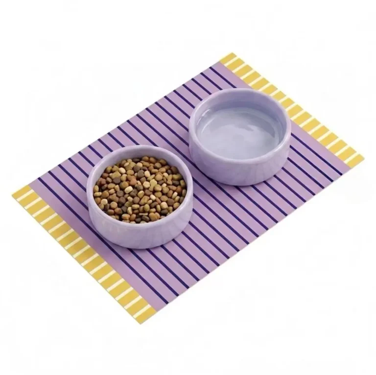 Two purple ceramic bowls placed on top of the spillproof pet food mat