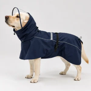 Dog wearing a navy blue waterproof rain suit with transparent hood visor and reflective trim.